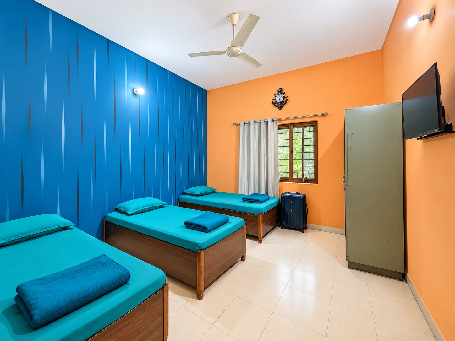 Second shared accommodation room with three neatly made beds