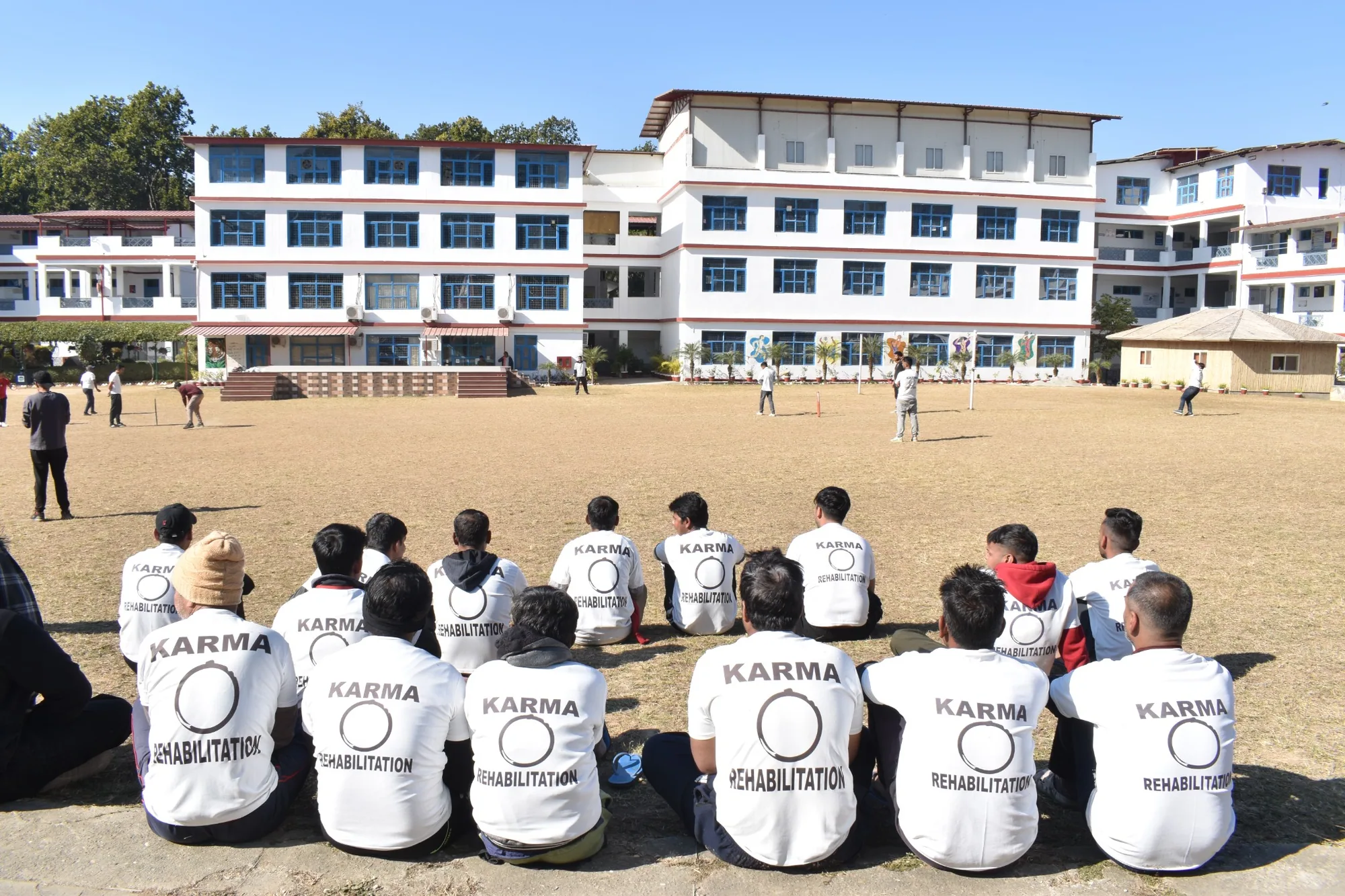 Karma team taking part in an outdoor cricket activity