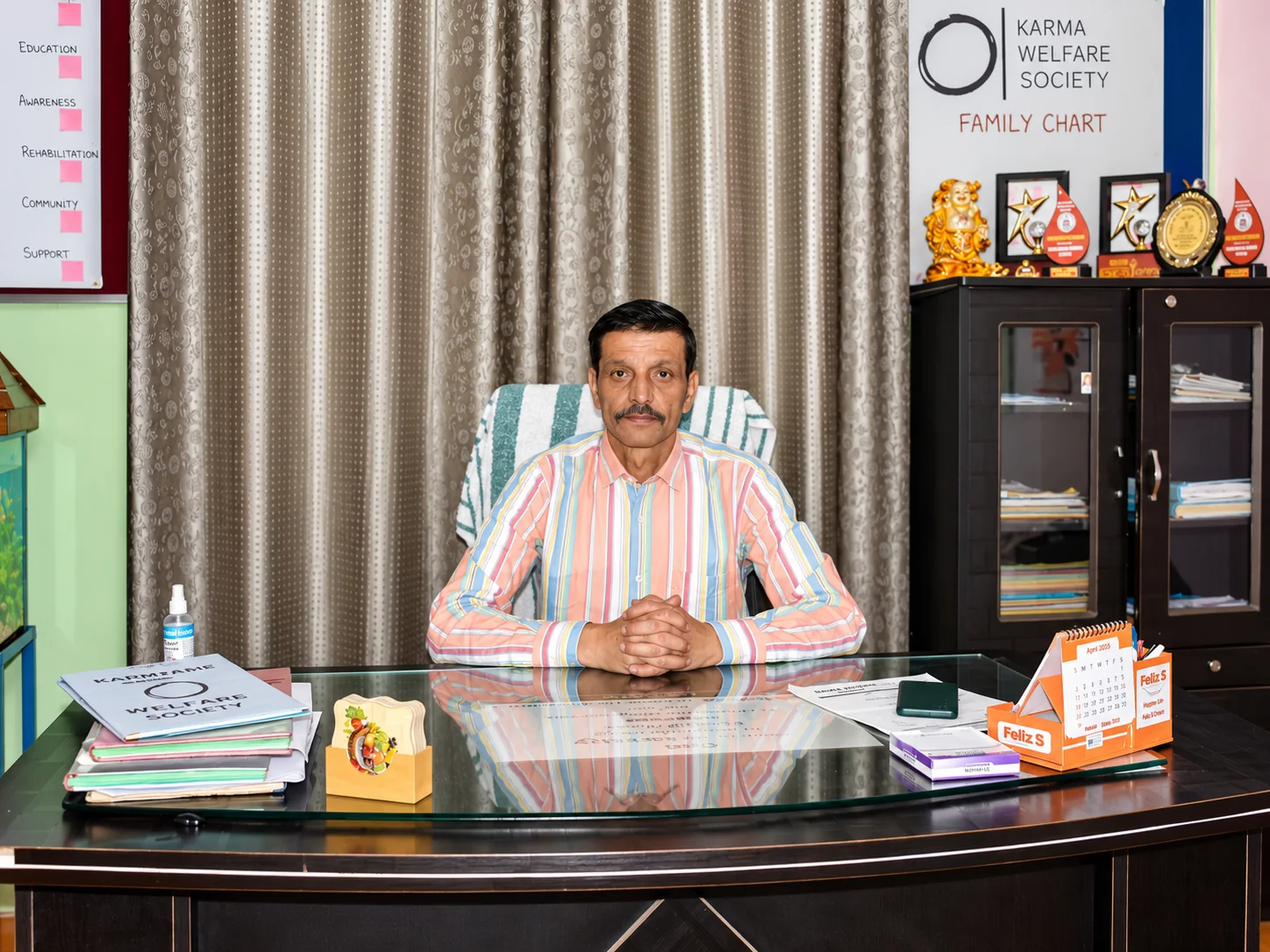 Ravinder Singh seated at his desk at Karma Welfare Society